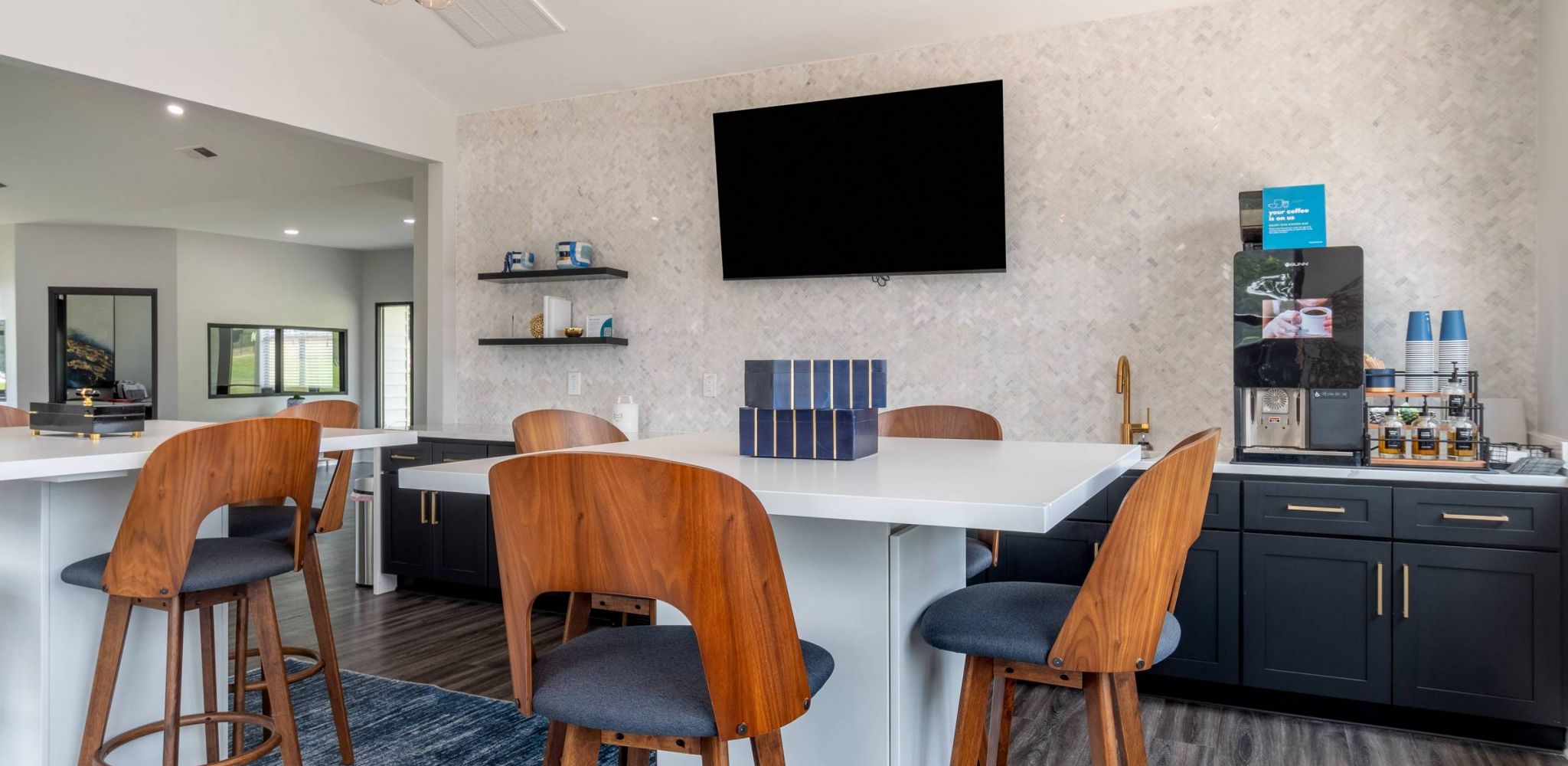 Hawthorne at the Pines resident clubhouse area with bar style seating and a flatscreen tv